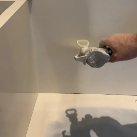 Spraying a white finish on a built-in
