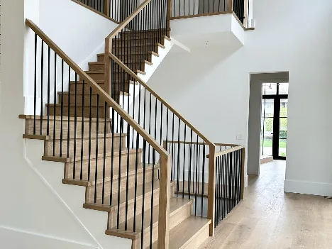 Staircase with stained treads and black railings