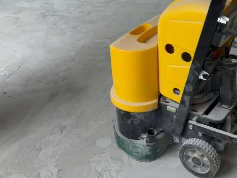 Concrete grinder on a garage floor before the coating